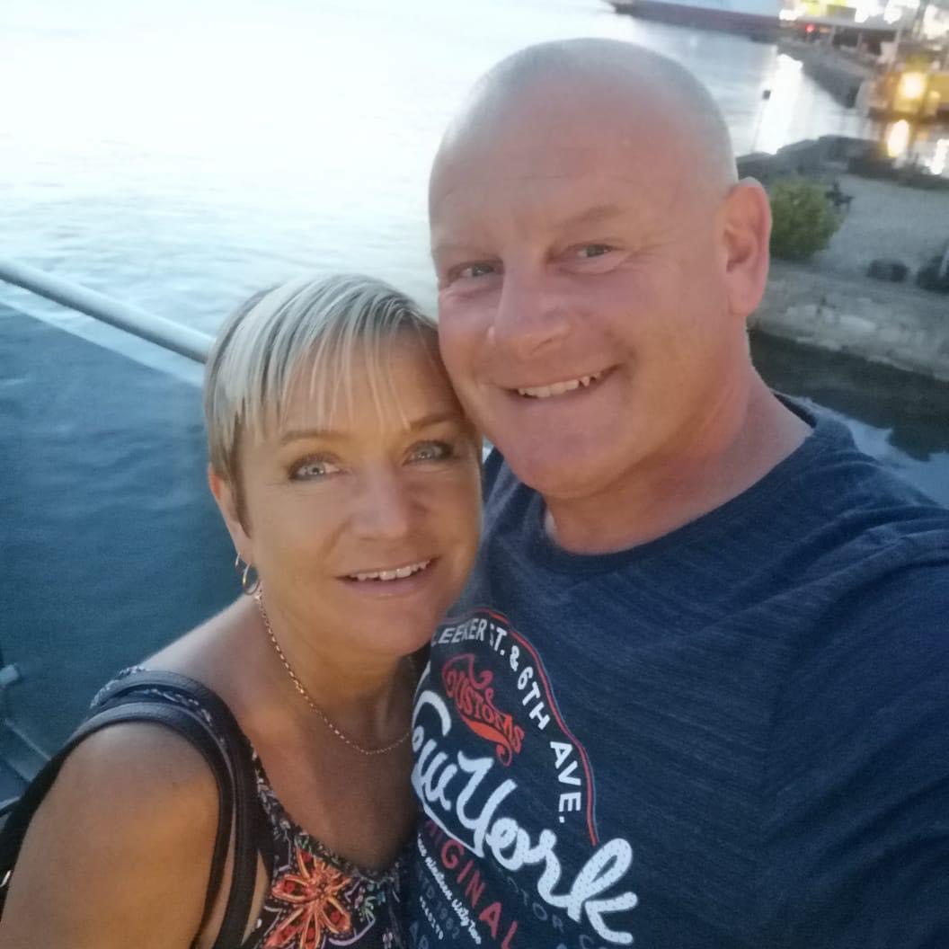 Simon Bull with his wife by the water
